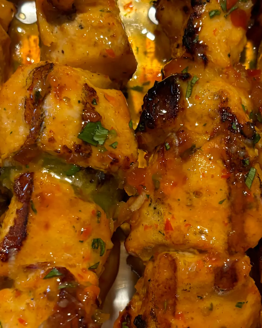 Glazed grilled chicken skewers on a catering tray